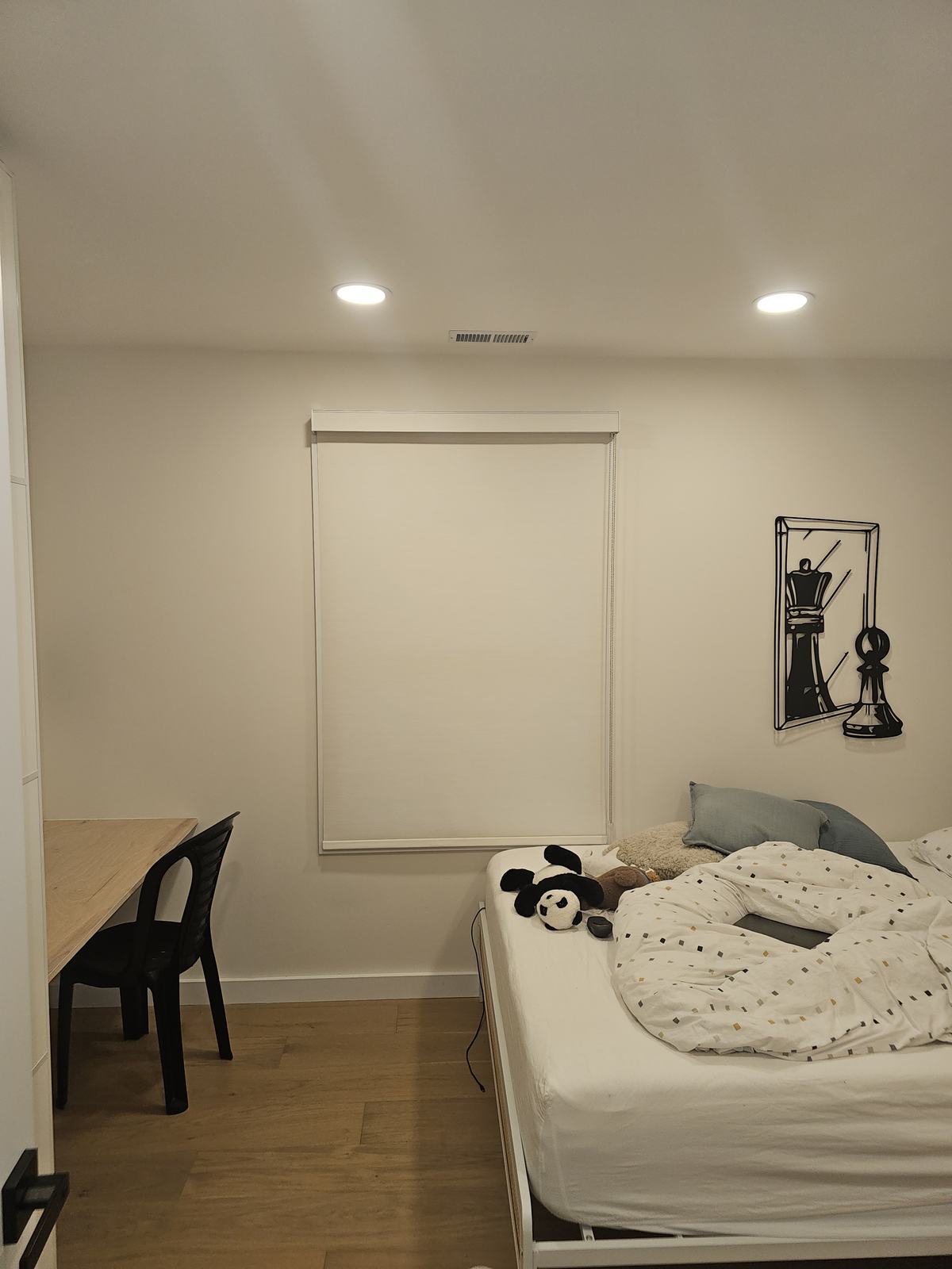 Blackout roller shade fully lowered over a child's bedroom window in a ModuShade installation