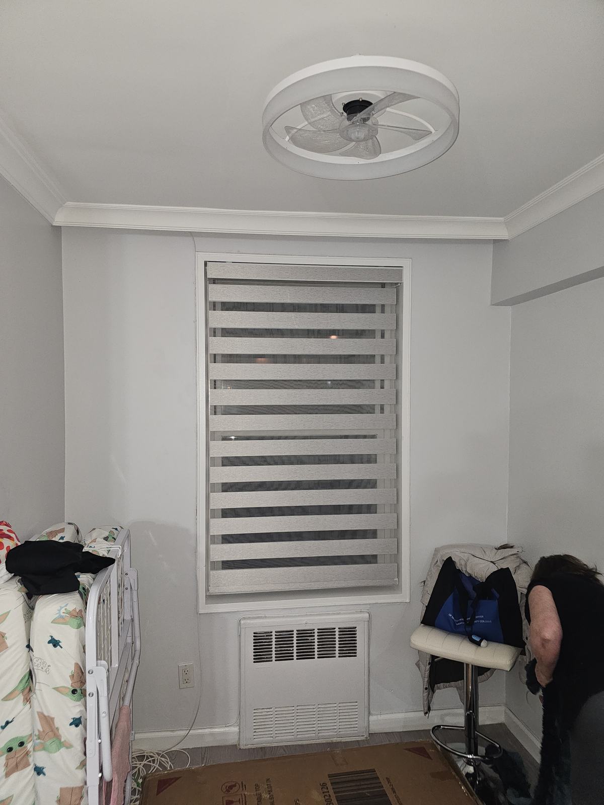 Zebra shade fitted in a period-home bedroom alcove, stopped short of the radiator below
