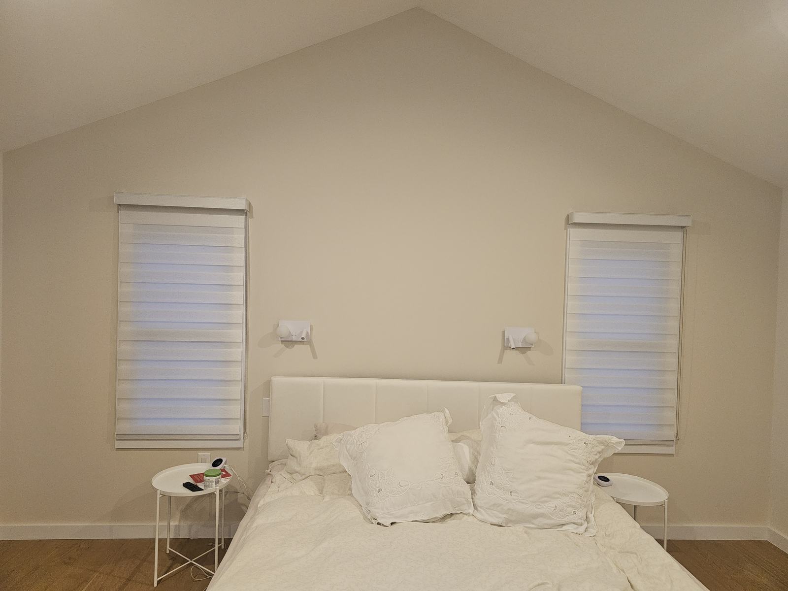 Zebra shades fitted under the vaulted ceiling of a finished attic bedroom in a single-family home